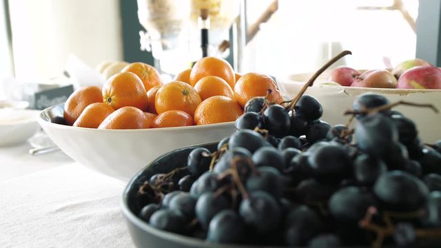 lots of fruit in plates on the table