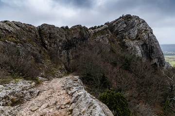 The mountain over grotto of Mary Magdalene at cloudy weather, clouds over a valley, a dry grass