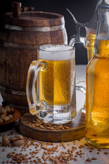 Light frothing beer in a glass, on an old background.