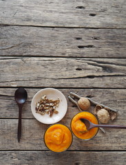 Health benefits of pumpkin. Pumpkin pulp is passed through a blender. Natural smoothie made at home on a natural wooden table. Place for text.Top view.