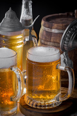 Light frothing beer in a glass, on an old background.