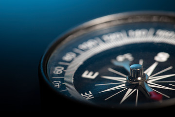 Vintage Magnetic compass compass on blue background. Macro photo - 334837688