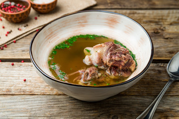 soup with veal on wooden table