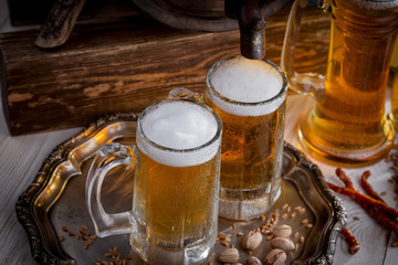 Light beer in a glass, on an old background.