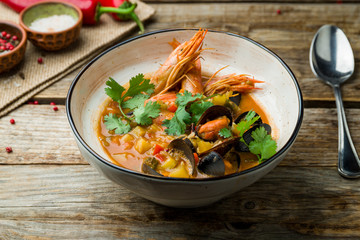 Seafood casserole bowl on wooden table