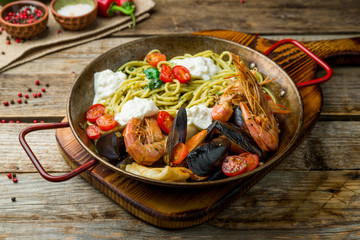 Pasta with seafood on old wooden table