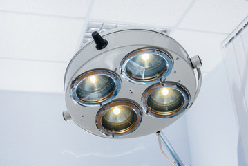 Modern medical lamp close-up in a light operating room. Medicine and surgery