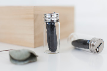 Vegan dental floss with bamboo charcoal in a glass container, eco-friendly zero waste life