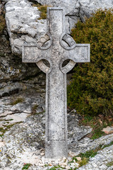 The sacred cross St.Pilon is on the mountain in cloudy weather, clouds over a valley, a dry grass, mountain over grotto of Mary Magdalene