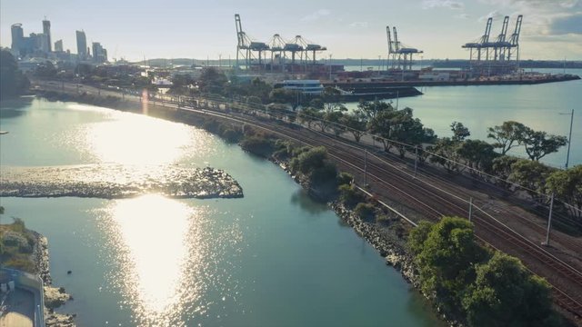 Aerial: Passenger train and port of Auckland, New Zealand. 31 March 2020