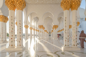 Interior of Sheikh Zayed Grand Mosque Center, Abu Dhabi. The largest mosque in United Arab Emirates or UAE. Muslim or Islamic white architecture building. Landmark tourist attraction.