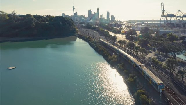 Aerial: Passenger train and port of Auckland, New Zealand. 31 March 2020