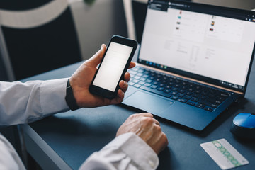 Online payment, woman's hands holding a credit card and using smart phone for online shopping. Business,financial  concept.