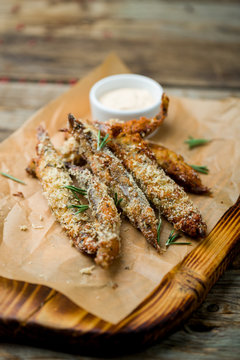 fried surmullet on board on old table