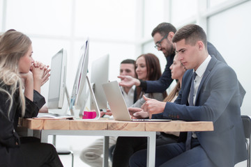 employees work on computers in a modern office