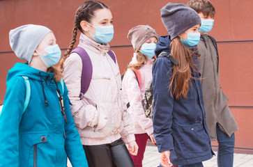 city residents adults and children observe quarantine and go in masks.