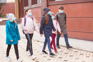 city residents adults and children observe quarantine and go in masks.