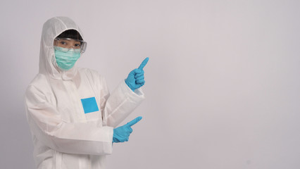 Asian doctor woman wear PPE suit or Personal Protective Equipment and medical mask and gloves which use for protect covid-19 virus pandemic from Wuhan China 