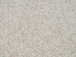 Texture of brown artificial stone with light flecks.