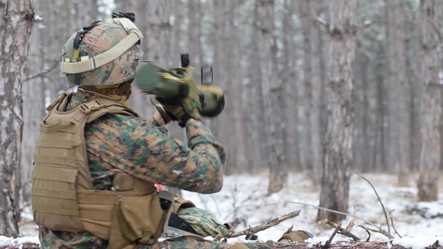 In the winter forest. Soldier takes Man-portable air-defense systems and aims