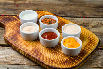 assorted sauces top view on wooden table