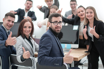 group of young professionals showing thumbs up
