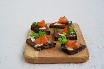 Appetizer, open sandwiches on rye bread with slightly salted salmon and butter. Swedish cuisine. Selective focus.