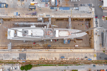 Aerial view of sea dry dock in La Ciotat city, France, the cargo crane, boats on repair, a luxury...