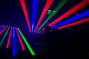 Night Club's Laser Beam Lights Crossing Fog