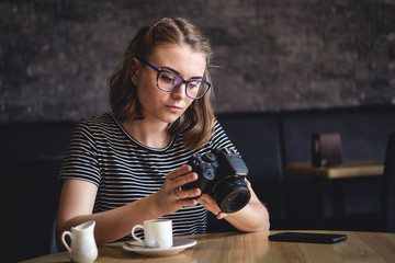 Young woman photographing chimping her photos