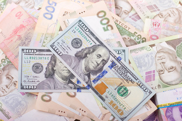 US dollars and Ukrainian hryvnia isolated on white. Exchange rates in Ukraine.