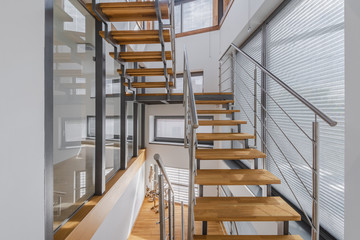 Interior with wooden stairs and large windows