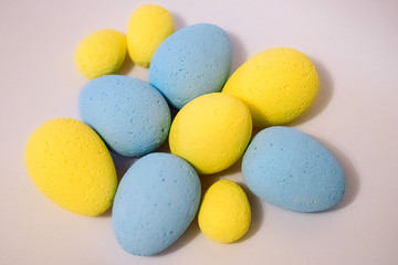Multi-colored eggs made of polystyrene, Easter decor for studios made of polystyrene foam on a white background