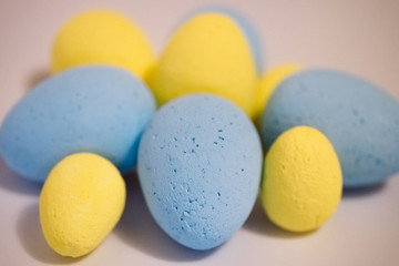 Multi-colored eggs made of polystyrene, Easter decor for studios made of polystyrene foam on a white background