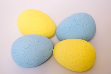 Multi-colored eggs made of polystyrene, Easter decor for studios made of polystyrene foam on a white background