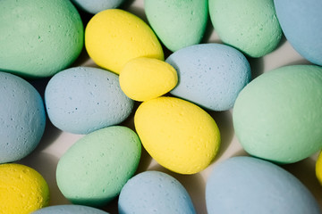 Multi-colored eggs made of polystyrene, Easter decor for studios made of polystyrene foam on a white background