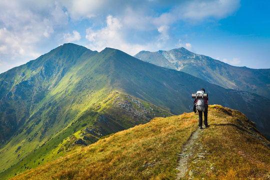 Hiking Trough Epic Mountain Landscape With A Big Backpack, Exploring And Feeling The Freedom Of Nature