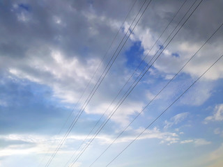 Fototapeta premium Electric wires on a background of clouds