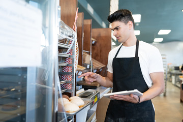 Worker doing inventory at a bakery