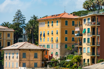 Fototapeta na wymiar Bright and colorful Italian cityscape. Sunlit streets. Colorful houses. Warm and comfortable.