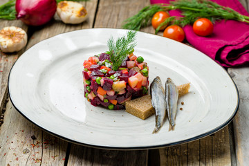 Vinaigrette on a white plate with herring