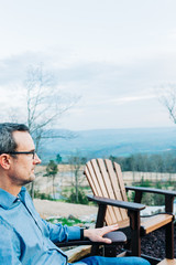 Fototapeta premium Man Relaxing By Outdoor Fire Pit