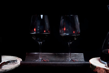 Two wine glasses filled on top of a tile