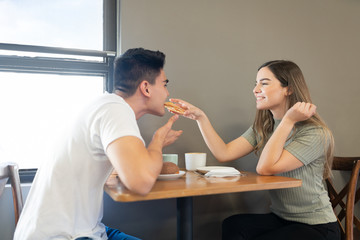 Woman sharing food with boyfriend