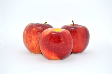  three red, juicy, ripe apples on a white background. apple source of vitamins and iron
