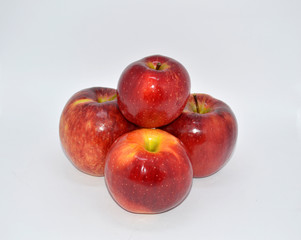 Fototapeta na wymiar four red, juicy, ripe apples on a white background. apple source of vitamins and iron