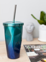 azure-blue thermo-cup with a metal tube for tasty drinks with you, a beautiful thermo-glass for every day in the style of zero waste. Eco life