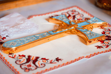 The Sacrament of Baptism. Attributes of the Orthodox priest for baptism, the cross. Baptism font.
