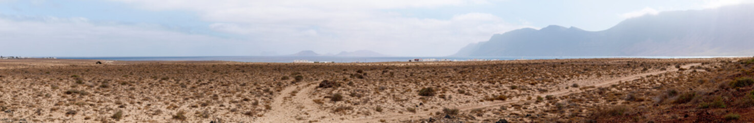 Fototapeta na wymiar Island desert with dirt road