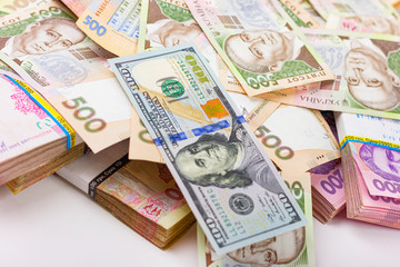 US dollars and Ukrainian hryvnia isolated on white. Exchange rates in Ukraine.